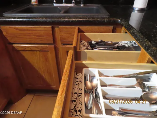 a view of kitchen with kitchen island and stainless steel appliances