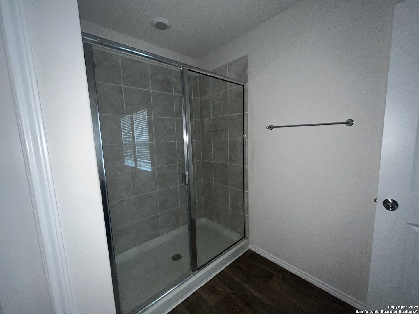 324 Middle Green Loop Floresville, TX 78114 - Photo 17 of 30 a bathroom with a glass shower door