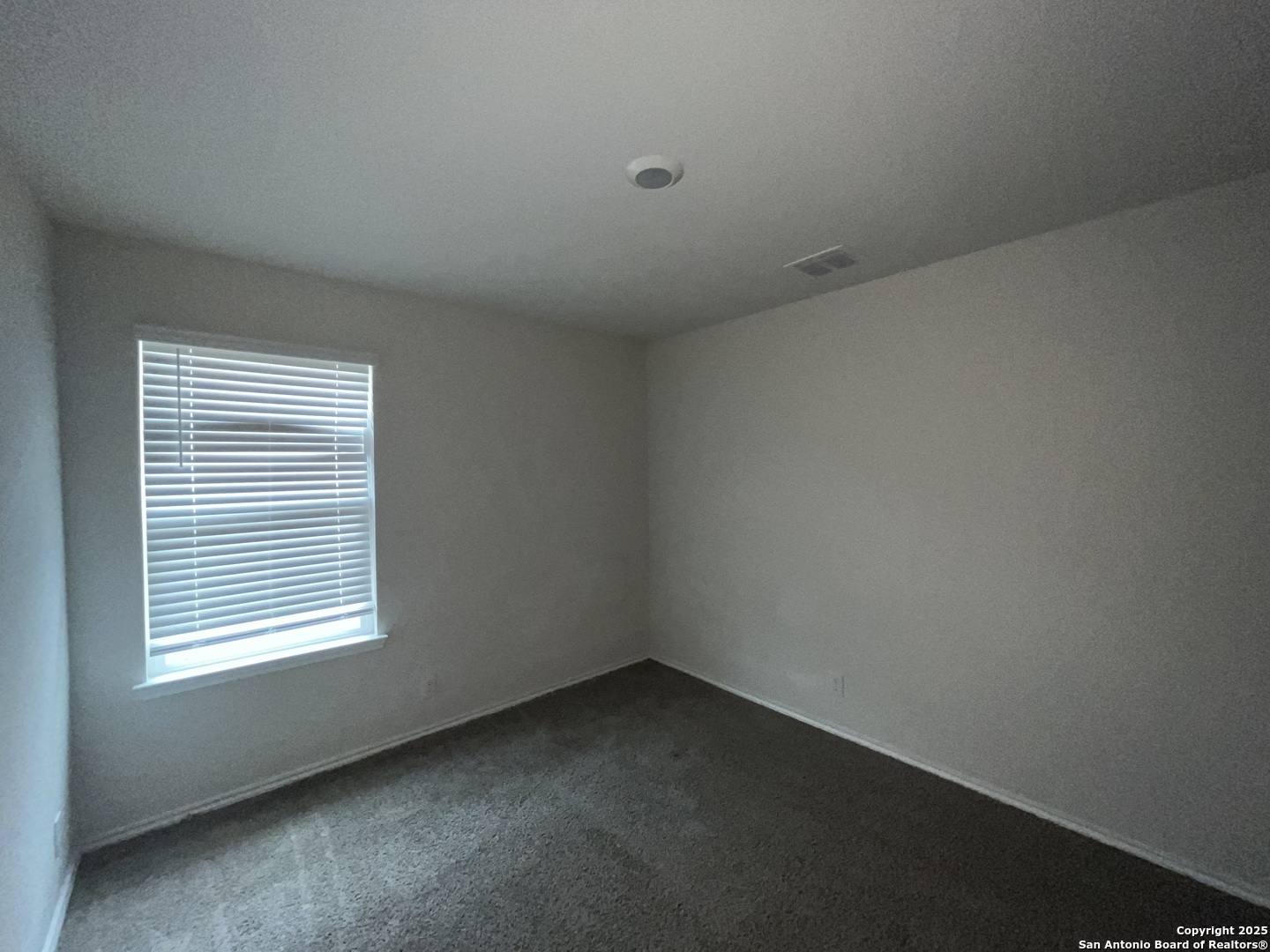 324 Middle Green Loop Floresville, TX 78114 - Photo 21 of 30 an empty room with a window