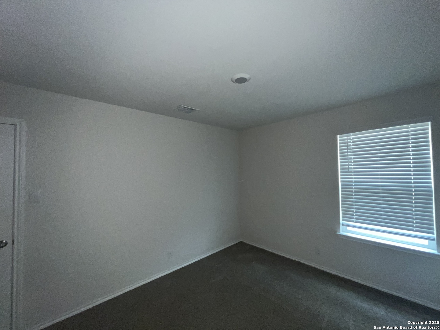 324 Middle Green Loop Floresville, TX 78114 - Photo 25 of 30 an empty room with a window