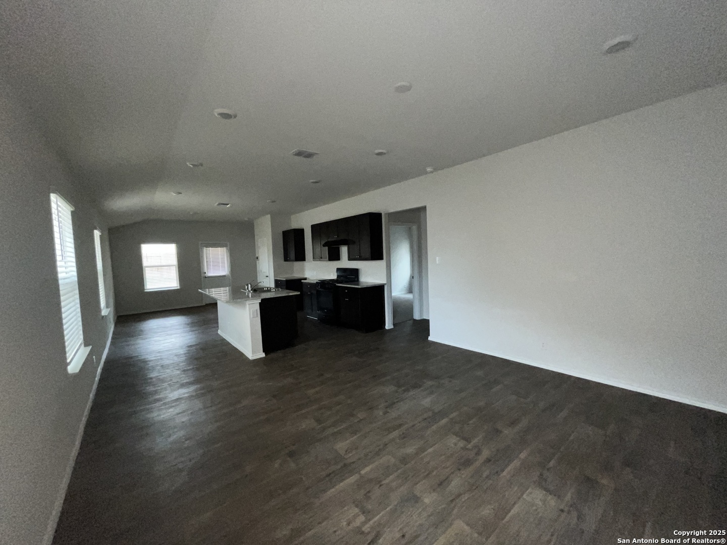 324 Middle Green Loop Floresville, TX 78114 - Photo 3 of 30 a view of empty room with wooden floor and windows