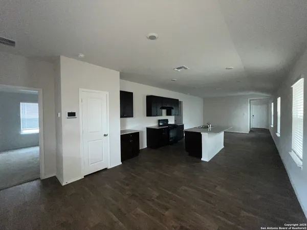 a kitchen with a refrigerator and a stove top oven