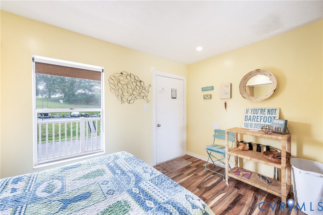 1085 Bluewater Drive, Unit 208 Moneta, VA 24121 - Photo 15 of 45 a bedroom with a bed and wooden floor