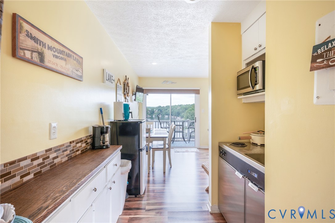 1085 Bluewater Drive, Unit 208 Moneta, VA 24121 - Photo 16 of 45 a kitchen with stainless steel appliances granite countertop a sink stove and cabinets