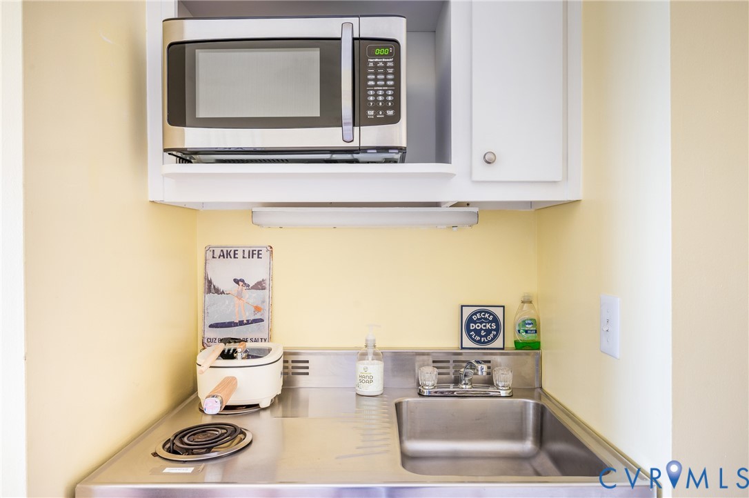 1085 Bluewater Drive, Unit 208 Moneta, VA 24121 - Photo 18 of 45 a bathroom with a sink a mirror and a toilet