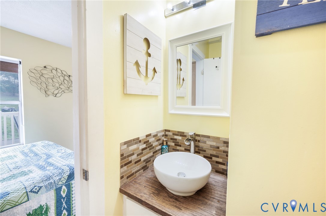 1085 Bluewater Drive, Unit 208 Moneta, VA 24121 - Photo 25 of 45 a bathroom with a granite countertop sink and a mirror