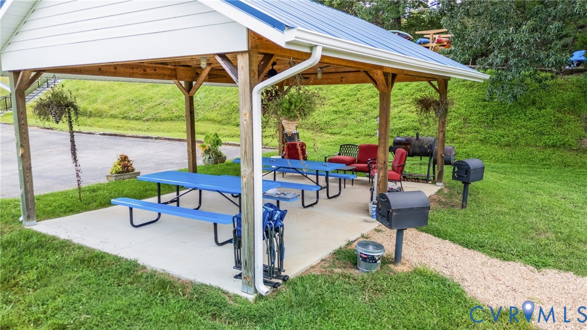 1085 Bluewater Drive, Unit 208 Moneta, VA 24121 - Photo 36 of 45 a view of swimming pool with a table and chairs under an umbrella