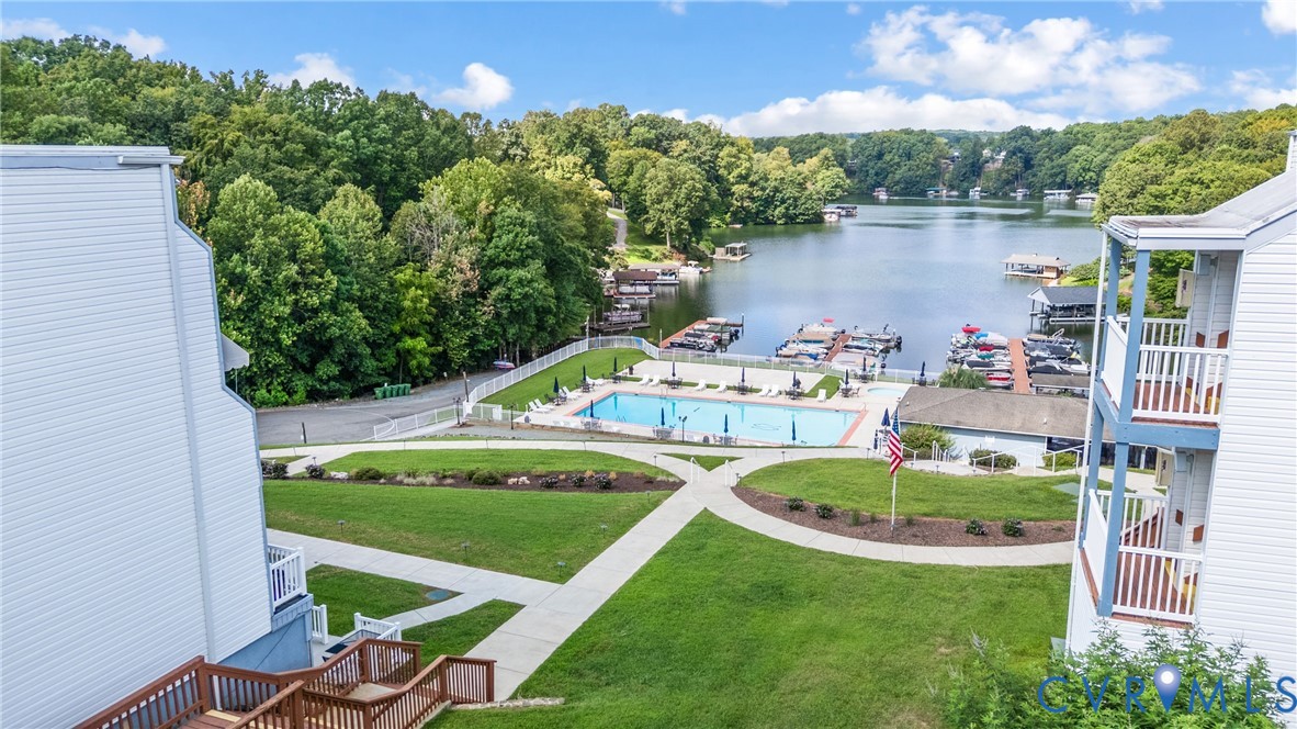 1085 Bluewater Drive, Unit 208 Moneta, VA 24121 - Photo 4 of 45 a table and chairs sitting in the middle of a lake