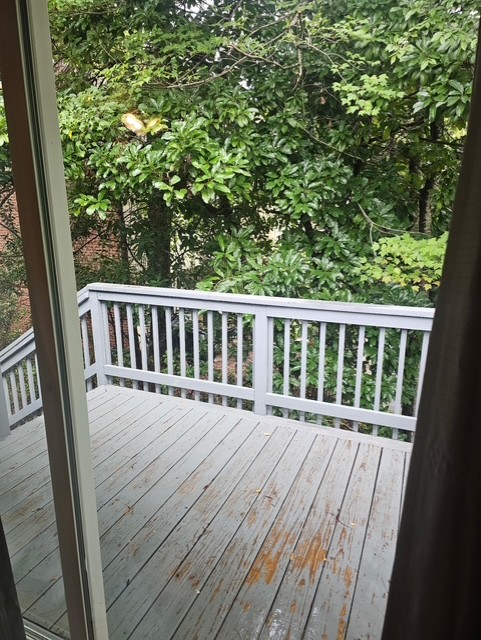 114 Houston Street Clemson, SC 29631 - Photo 18 of 19 Sliding glass doors open directly onto a private wooden deck framed by leafy green trees.