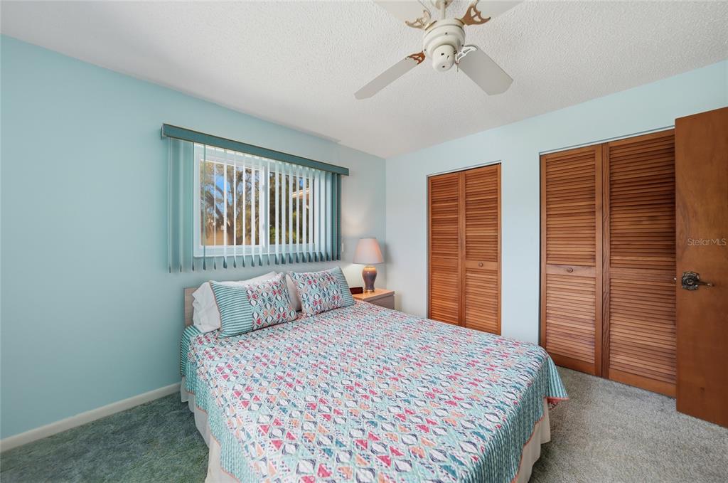 23035 Rye Avenue Punta Gorda, FL 33980 - Photo 14 of 20 a bedroom with a large bed and a chandelier