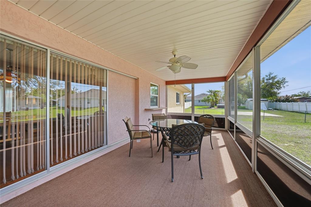 23035 Rye Avenue Punta Gorda, FL 33980 - Photo 16 of 20 a view of a patio with chairs and floor to ceiling window