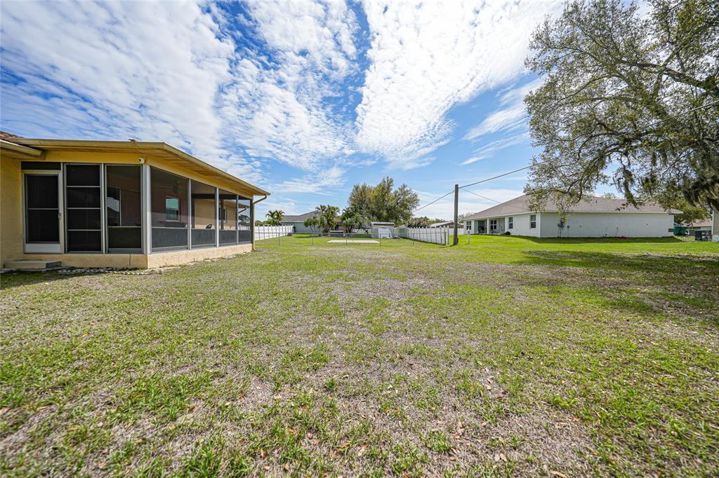 23035 Rye Avenue Punta Gorda, FL 33980 - Photo 18 of 20 a front view of a house with a garden and trees