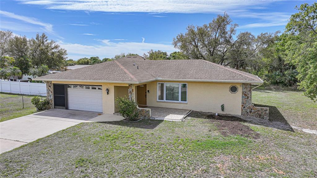 23035 Rye Avenue Punta Gorda, FL 33980 - Photo 3 of 20 a view of a house with a yard and large tree