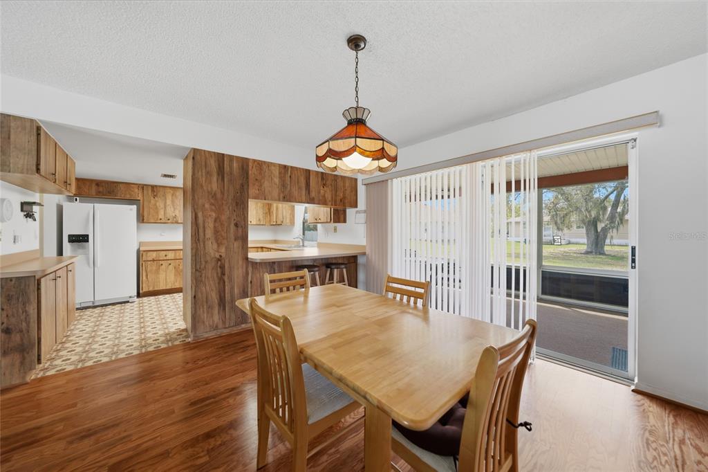23035 Rye Avenue Punta Gorda, FL 33980 - Photo 6 of 20 a dining room with furniture a chandelier and wooden floor