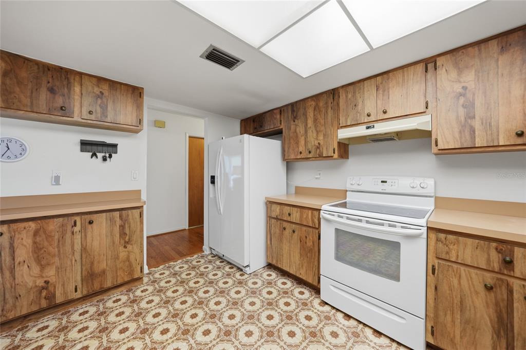 23035 Rye Avenue Punta Gorda, FL 33980 - Photo 7 of 20 a kitchen with stainless steel appliances granite countertop a refrigerator sink and cabinets