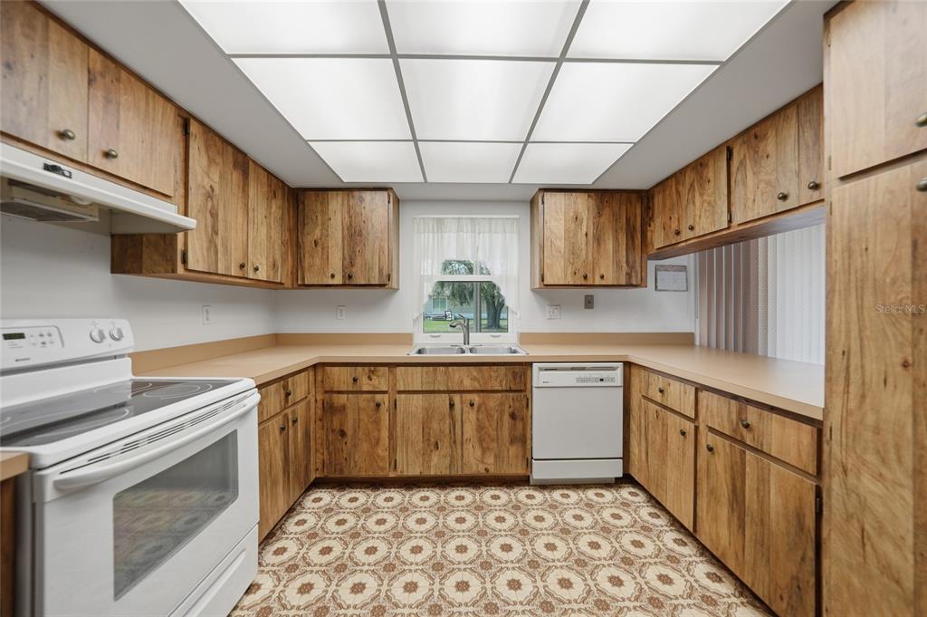 23035 Rye Avenue Punta Gorda, FL 33980 - Photo 8 of 20 a kitchen with stainless steel appliances granite countertop a sink a stove a refrigerator and cabinets