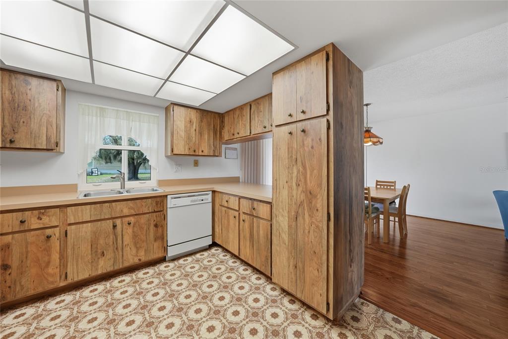 23035 Rye Avenue Punta Gorda, FL 33980 - Photo 9 of 20 a kitchen with stainless steel appliances granite countertop a refrigerator a sink and white cabinets