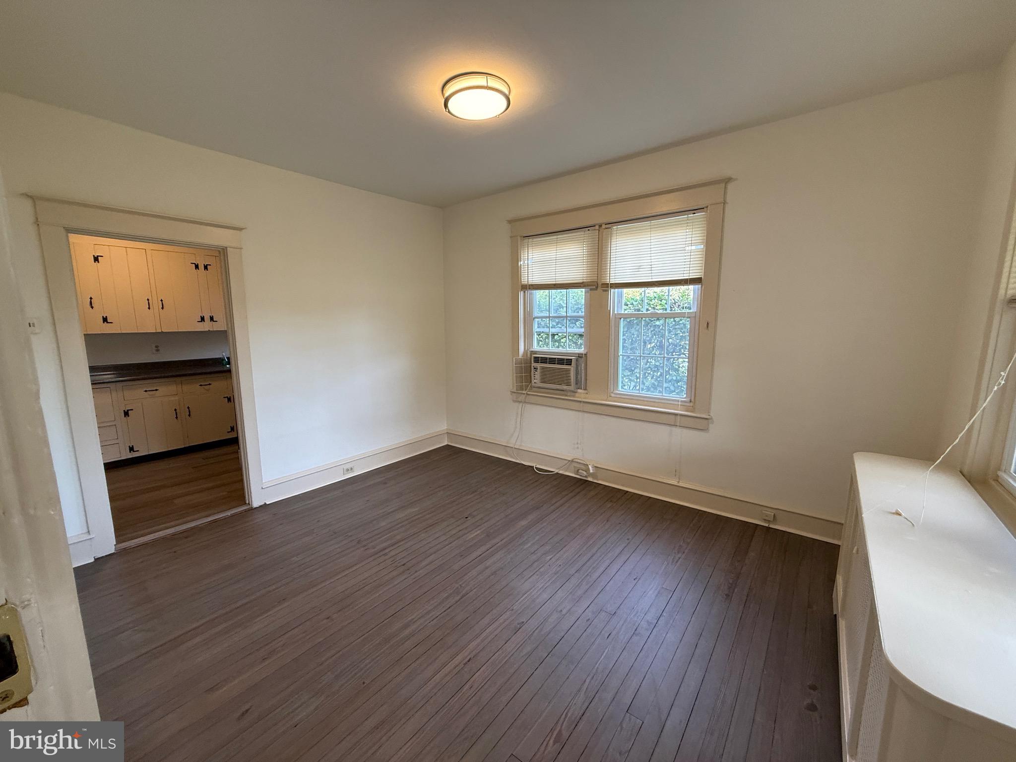 305 West Wayne Avenue, Unit 1 Wayne, PA 19087 - Photo 2 of 9 wooden floor in an empty room with a window