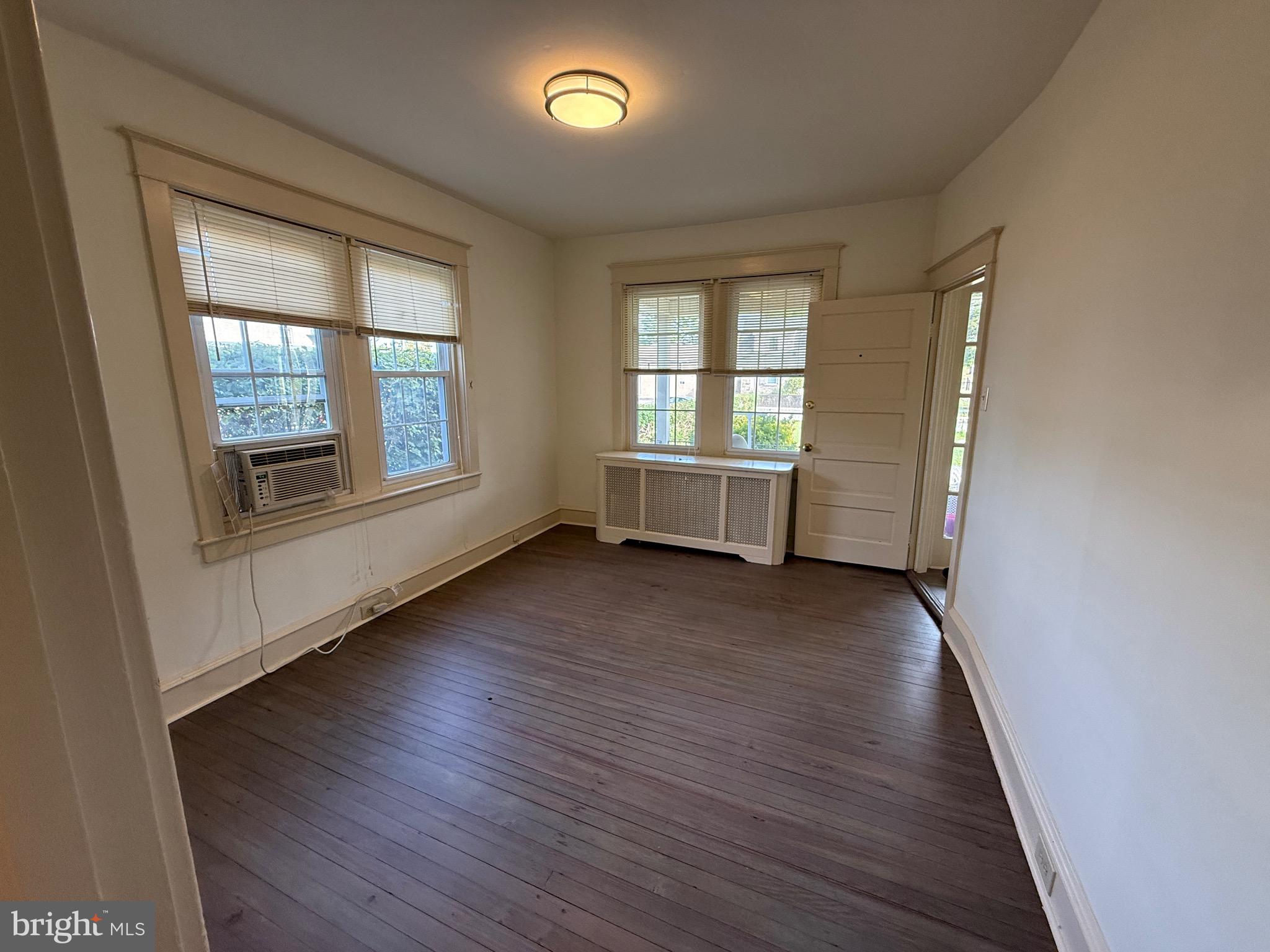 305 West Wayne Avenue, Unit 1 Wayne, PA 19087 - Photo 3 of 9 an empty room with wooden floor and windows