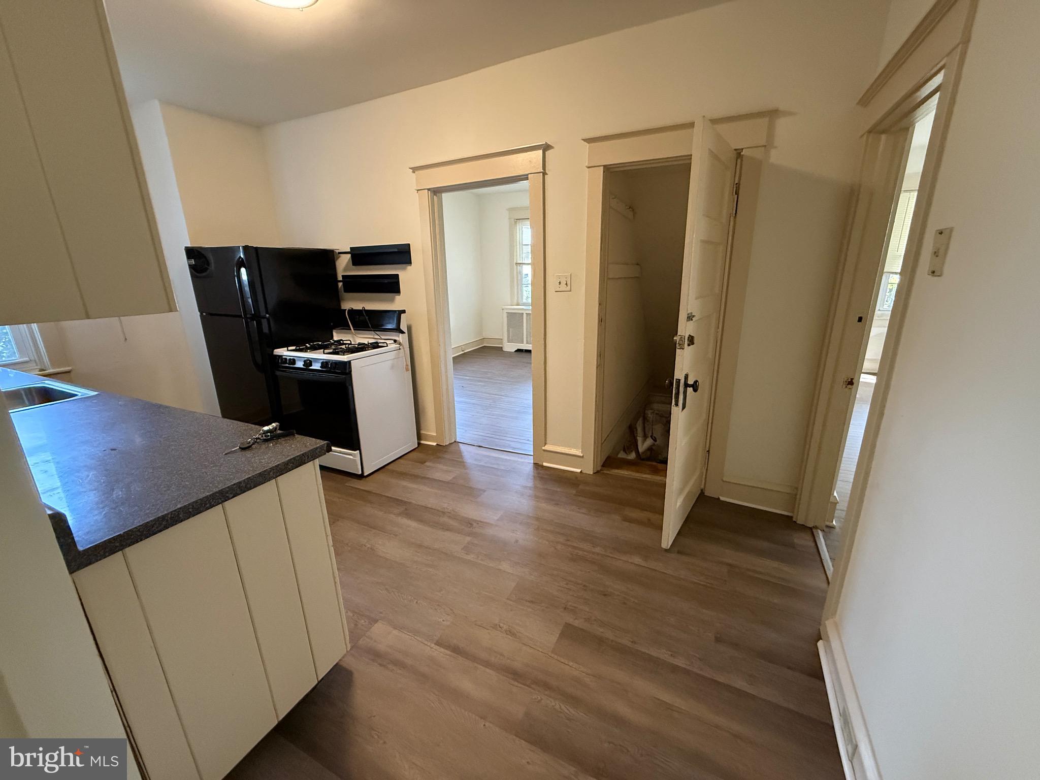 305 West Wayne Avenue, Unit 1 Wayne, PA 19087 - Photo 8 of 9 a view of a kitchen with refrigerator and wooden floor