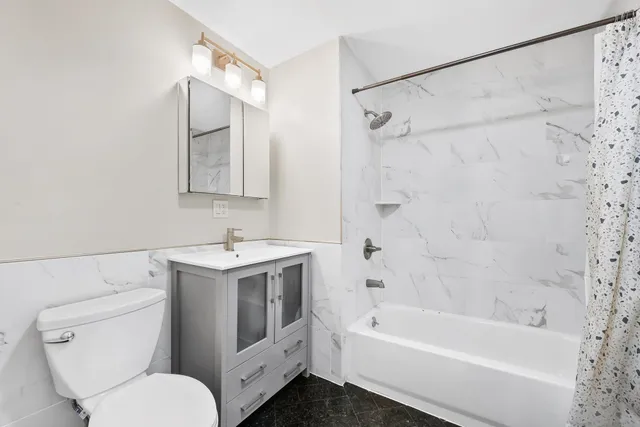 a bathroom with a sink toilet and shower