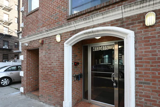 a front view of a building with parking space