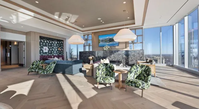 a living room with furniture and a chandelier