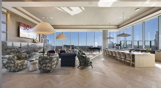 a large living room with stainless steel appliances kitchen island granite countertop a large kitchen counter top and couches