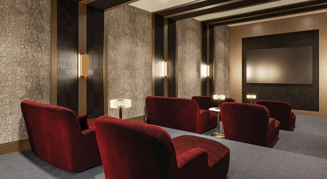 a view of a patio with couches chairs and a floor to ceiling window