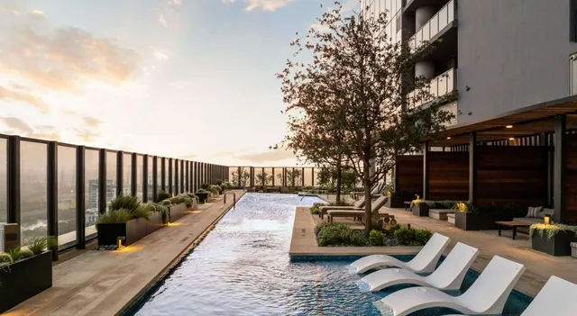a living room with a floor to ceiling window and furniture
