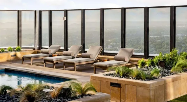 a building outdoor space with patio couches and potted plants