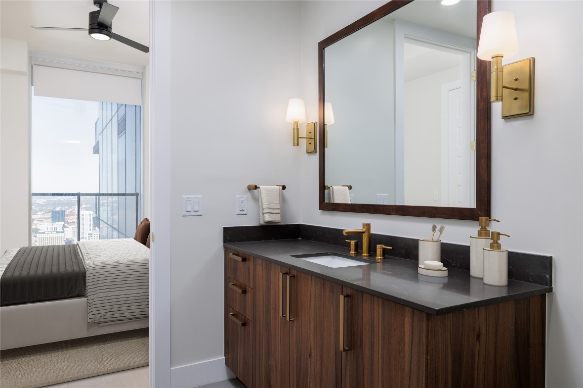 600 Guadalupe Street, Unit 5807 Austin, TX 78701 - Photo 5 of 28 a bathroom with a sink and a mirror