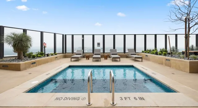 a view of a swimming pool and outdoor seating