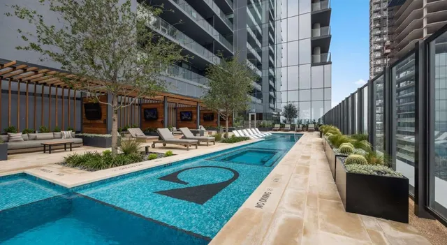 a view of swimming pool with outdoor seating and plants
