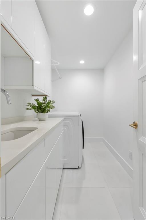 888 10th Street South, Unit 101 Naples, FL 34102 - Photo 24 of 31 a white bath tub sitting in a room next to a window