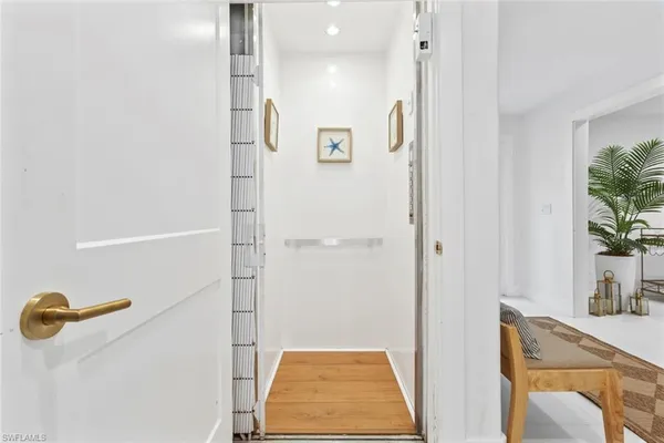 a living room with furniture a window and a potted plant