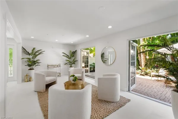 a living room with furniture and a potted plant