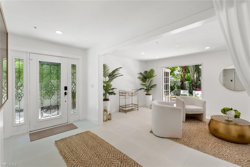 888 10th Street South, Unit 101 Naples, FL 34102 - Photo 27 of 31 a living room with furniture and a potted plant