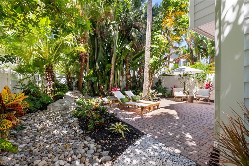888 10th Street South, Unit 101 Naples, FL 34102 - Photo 29 of 31 a view of a patio with table and chairs and potted plants