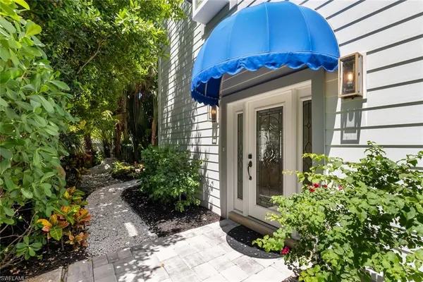 a view of a house with a small yard