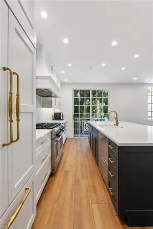 a kitchen with stainless steel appliances a sink stove and refrigerator
