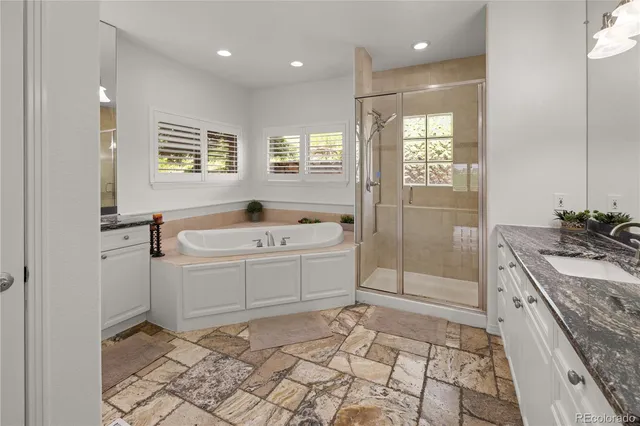 a bathroom with a sink a toilet a mirror and shower