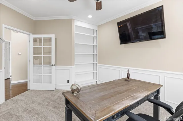 a room with a table and a flat screen tv