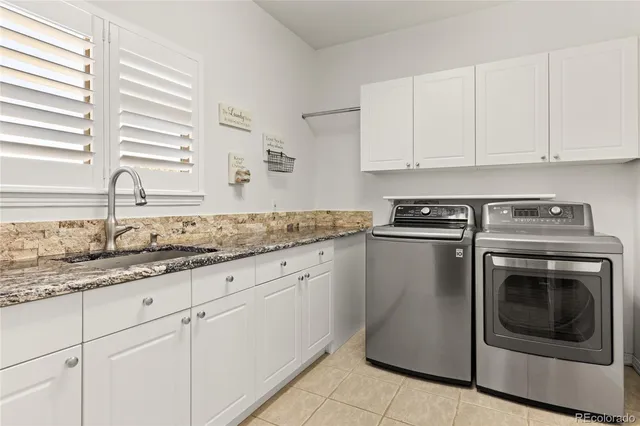 a kitchen with granite countertop white cabinets and white stainless steel appliances
