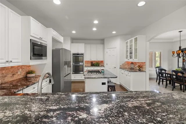 a kitchen with refrigerator and cabinets