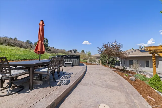 a view of a patio with a table and chairs