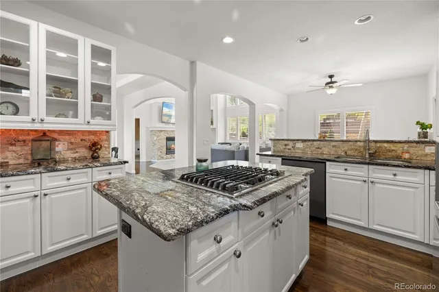 a kitchen with stainless steel appliances granite countertop a stove and cabinets