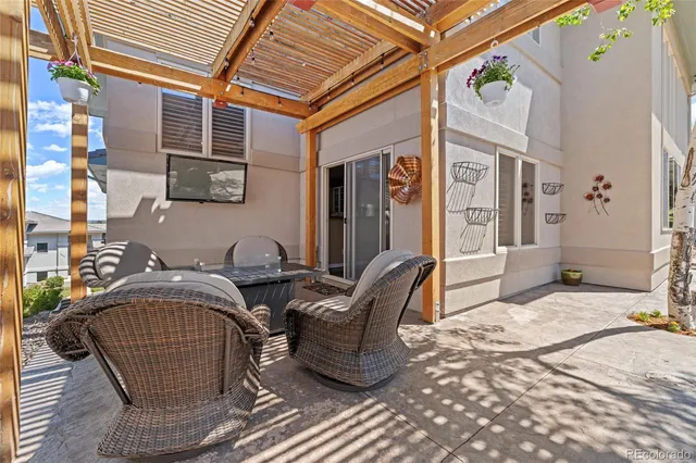 a view of a patio with a table and chairs
