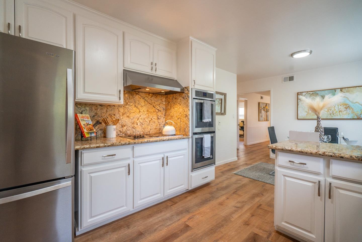 753 Peekskill Drive Sunnyvale, CA 94087 - Photo 16 of 33 a kitchen with granite countertop white cabinets and refrigerator