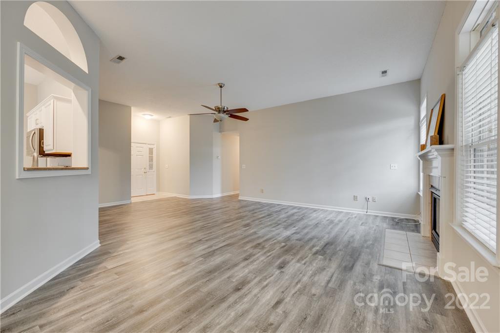 1307 Crown Ridge Drive Fort Mill, SC 29708 - Photo 7 of 24 a view of an empty room with wooden floor and a window